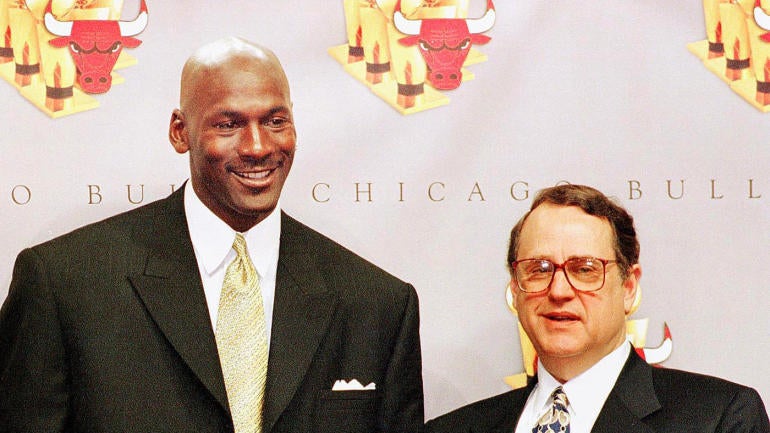 Michael Jordan (C) of the Chicago Bulls, holding h