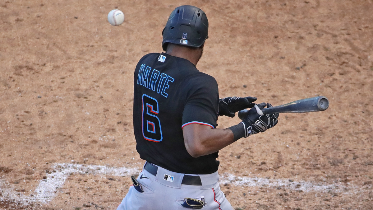 Miami Marlins' Starling Marte goes to the dugout after he was out at second  base during a spring training baseball game against the New York Mets,  Tuesday, March 23, 2021, in Port