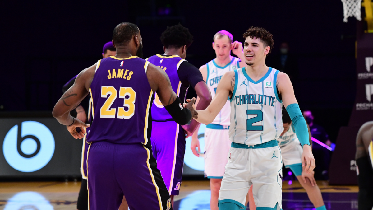 Los Angeles Lakers forward LeBron James, right, dunks past Charlotte  Hornets guard LaMelo Ball (2) during the first half of an NBA basketball  game Thursday, March 18, 2021, in Los Angeles. (AP