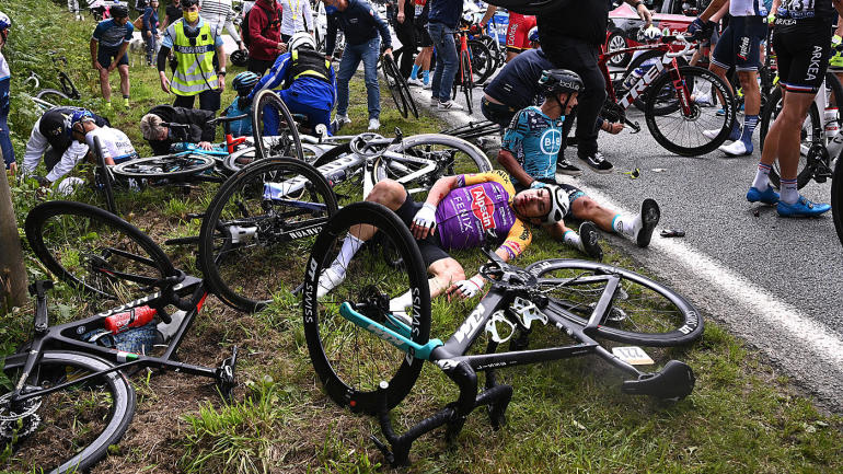 LOOK: Tour de France spectator causes massive crash in Stage 1 with a sign, and is now ...