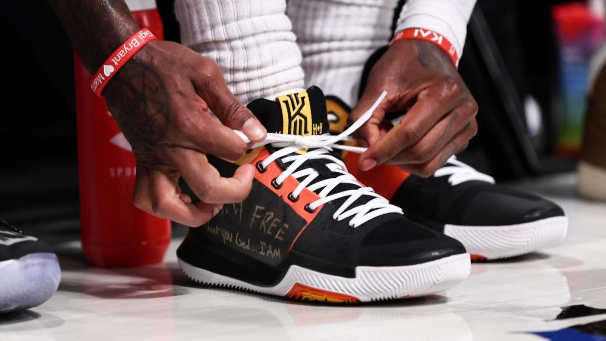 Kyrie Irving covers up Nike logo on sneakers with 'I am free,' 'LOGO HERE' messages - CBSSports.com
