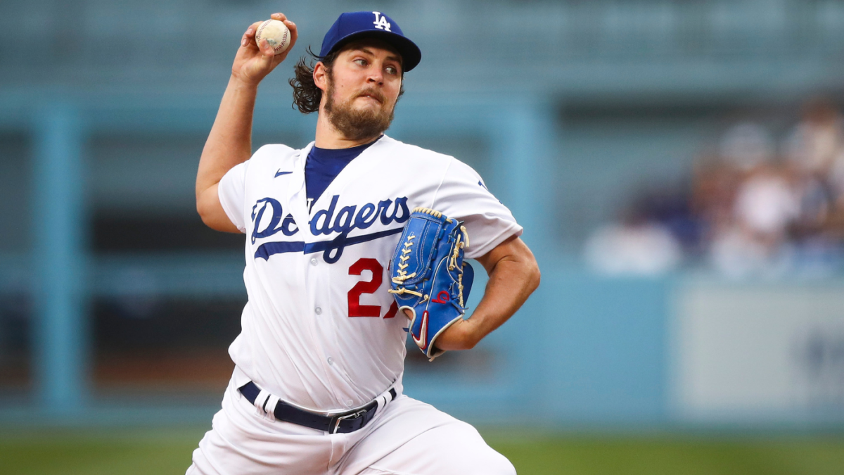 Trevor Bauer with his new uniform and cap of Yokohama DeNA BayStars poses  for photographers during a photo session of the news conference Friday,  March 24, 2023, in Yokohama, near Tokyo. (AP