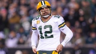 Aaron Rodgers of the Green Bay Packers is hit by DaQuan Jones and