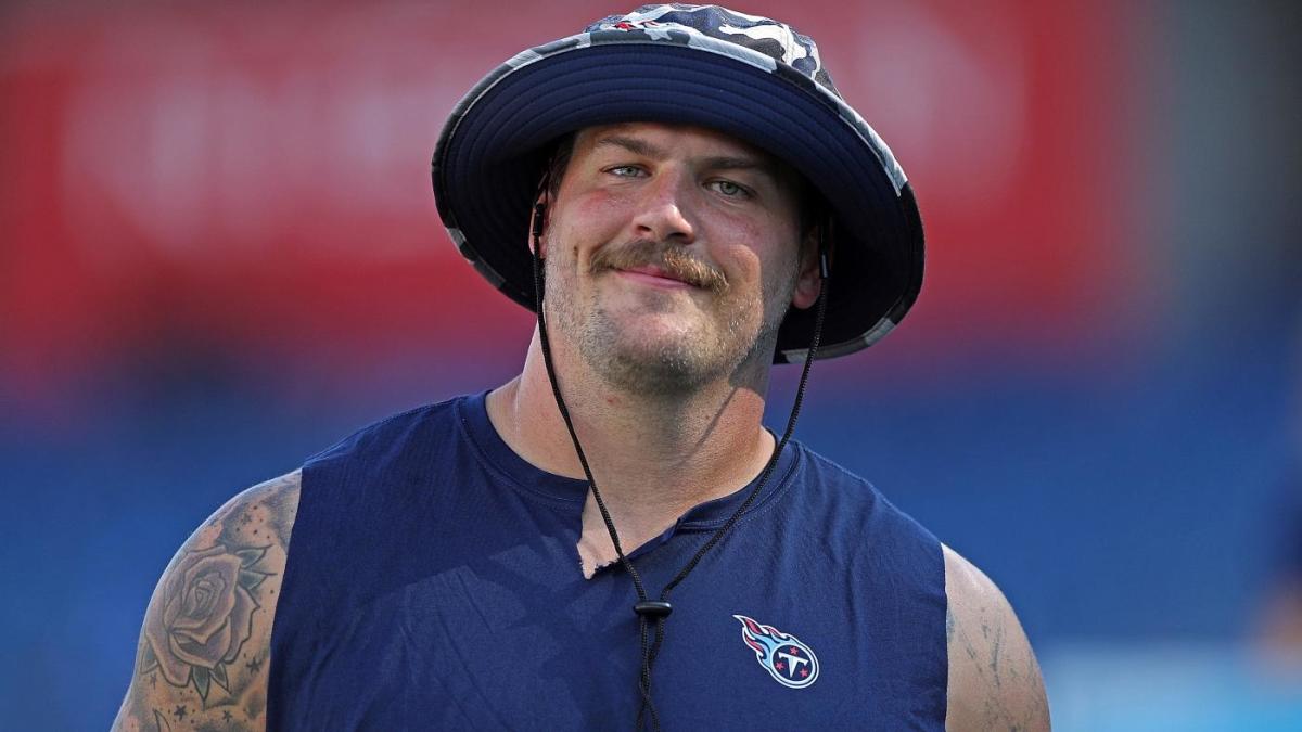 Tennessee Titans offensive tackle Taylor Lewan carries his daughter, Wynne,  1, as he leaves the field following the first day of practice at NFL  football training camp Thursday, July 26, 2018, in