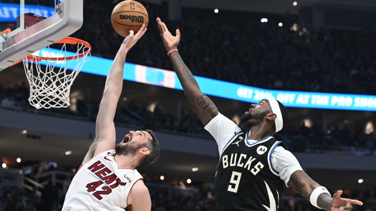 Apr 16, 2023; Milwaukee, Wisconsin, USA; Miami Heat forward Kevin Love (42) tips the ball in against Milwaukee Bucks forward Bobby Portis (9) in the first half during game one of the 2023 NBA Playoffs at Fiserv Forum. Mandatory Credit: Michael McLoone-USA TODAY Sports (NBA News)