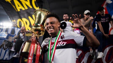 Dan Ndoye of Bologna FC celebrates with the trophy during