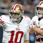 getty-mac-jones-christian-mccaffrey-49ers.jpg