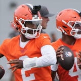 Cleveland Browns quarterbacks Shedeur Sanders (right) and Deshaun Watson take part in a drill on June 9 at CrossCountry Mortgage