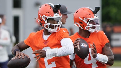 Cleveland Browns quarterbacks Shedeur Sanders (right) and Deshaun Watson take part in a drill on June 9 at CrossCountry Mortgage