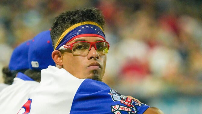 Franklin Arias watches WooSox teammates bat against Lehigh Valley August 4 at Polar Park.