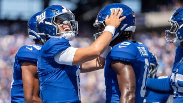 New York Giants quarterback Jaxson Dart (6) celebrates with New York Giants wide receiver Malachi Fields (0) after scoring a
