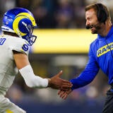 QB Matthew Stafford and coach Sean McVay high five during an NFL game.