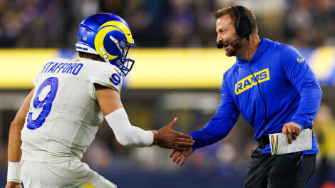 QB Matthew Stafford and coach Sean McVay high five during an NFL game.