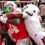 Ohio State Buckeyes wide receiver Jeremiah Smith (4) catches a touchdown pass defended by Ball State Cardinals defensive back