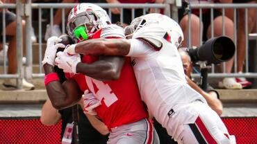 Ohio State Buckeyes wide receiver Jeremiah Smith (4) catches a touchdown pass defended by Ball State Cardinals defensive back