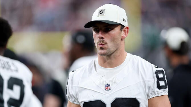 Raiders' Brock Bowers walks in his white jersey during a preseason game.