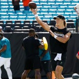 Jaguars QB Trevor Lawrence throws a football during warmups before Jacksonville's game against the Cleveland Browns.