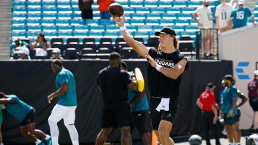 Jaguars QB Trevor Lawrence throws a football during warmups before Jacksonville's game against the Cleveland Browns.