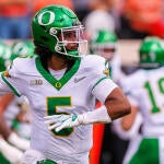 Number five Dante Moore throws a football during Oregon's opener against Oklahoma State.