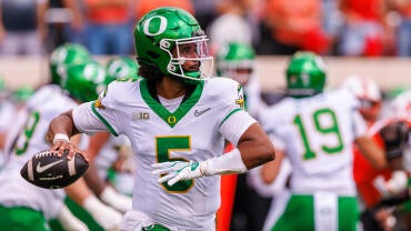 Number five Dante Moore throws a football during Oregon's opener against Oklahoma State.
