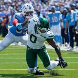 New York Jets running back Braelon Allen (0) can't pull down the ball in front of Tennessee Titans linebacker Anthony Hill Jr.