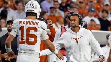 sarkisian-manning-texas-usatsi.jpg
