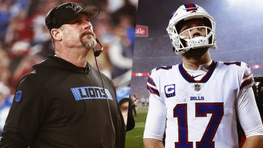 On one side is Lions' coach Dan Campbell looking up and on the other is Bills quarterback Josh Allen in a white number 17 jersey.