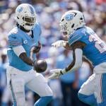 Tennessee Titans quarterback Cam Ward (1) hands off to running back Tony Pollard (20) during the third quarter against the New