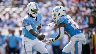 Tennessee Titans quarterback Cam Ward (1) hands off to running back Tony Pollard (20) during the third quarter against the New