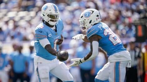 Tennessee Titans quarterback Cam Ward (1) hands off to running back Tony Pollard (20) during the third quarter against the New