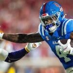 Ole Miss tight end Caleb Odom (4) stiff arms LSU safety Tamarcus Cooley (0) during a college football game between Ole Miss and