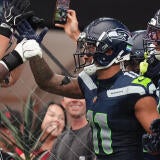 Seattle Seahawks receiver Jaxon Smith-Njigba (11) celebrates a touchdown against the Arizona Cardinals at State Farm Stadium in