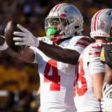Ohio State Buckeyes wide receiver Jeremiah Smith (4) reacts to a first down catch during the NCAA football game against the Iowa