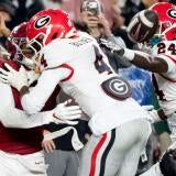 Oct 10, 2026; Tuscaloosa, Alabama, USA;  Georgia defensive back KJ Bolden (4) hits Alabama wide receiver Rico Scott (7) well