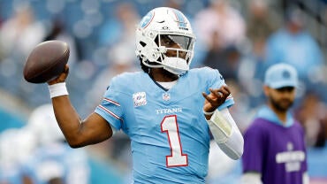 Titans QB Cam Ward, wearing a number 1 blue jersey, winds up to throw a football.