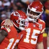 Patrick Mahomes puts his arm around Tyreek Hill and looks at him during a football game in 2022.