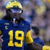 Michigan quarterback Bryce Underwood (19) runs off the field after his pass was intercepted by Penn State during the first half